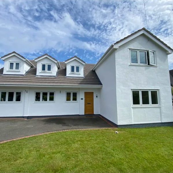 Large family home painted white with gold front door