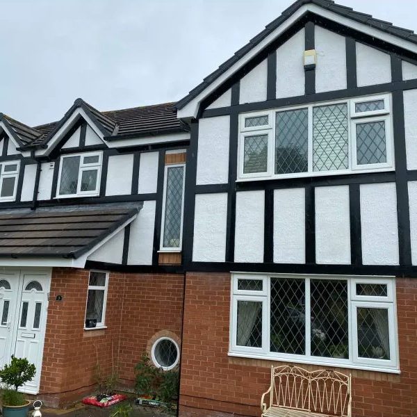 House with painted white walls and black wooden panels